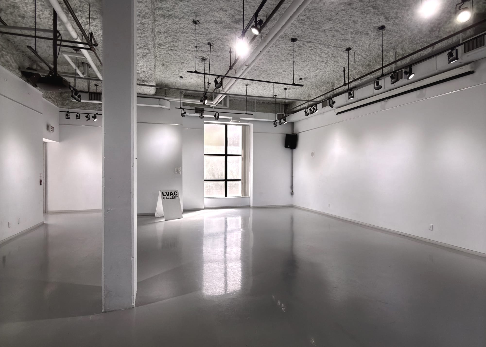 An empty gallery space with a sign that reads "LVAC Gallery."