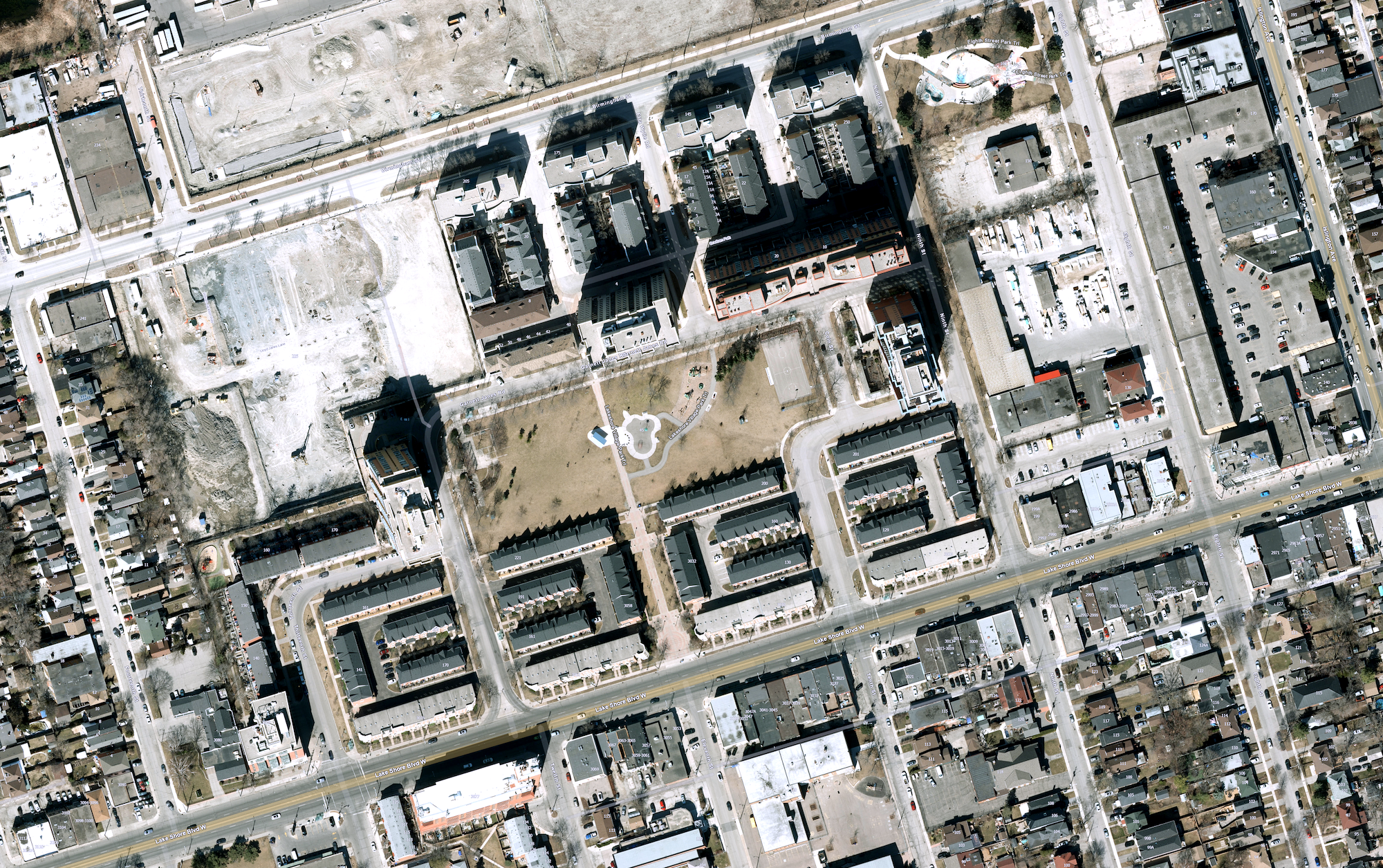 Aerial view of a residential Toronto neighbourhood, showing a large group of housing co-operatives arranged around a park.