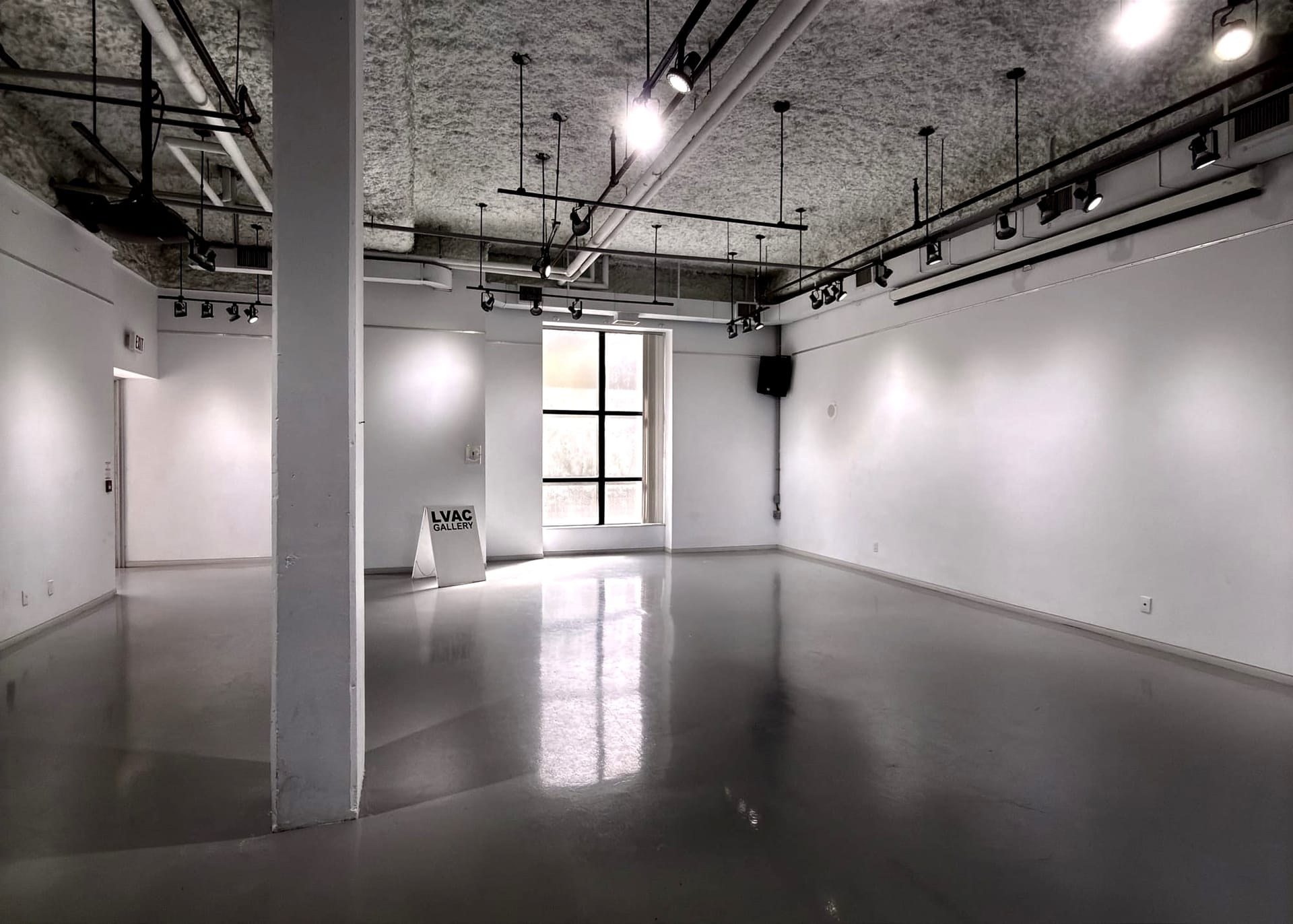An empty gallery space with a sign that reads "LVAC Gallery."